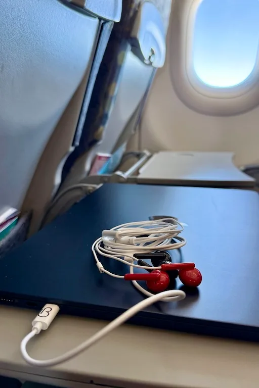 loveBuds with tablet on an airline tray table